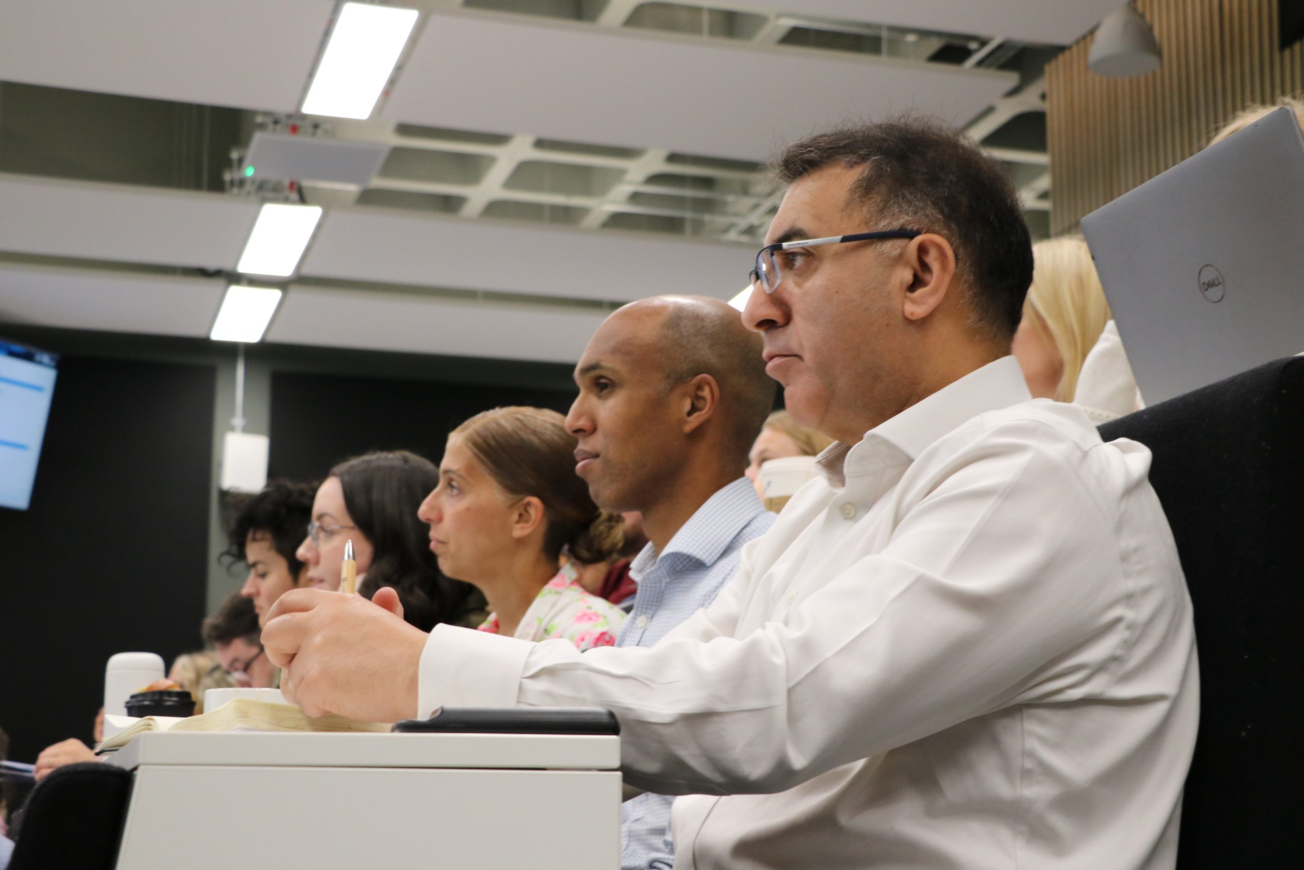 People sitting in a lecture theatre concentrating