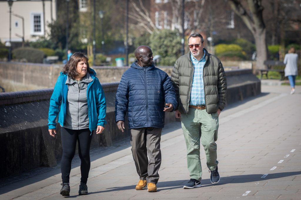 Three people walking outdoors